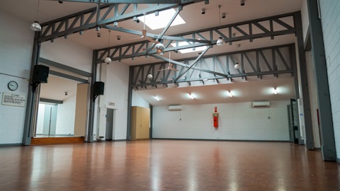 Hall space with lighting, wooden floor and stage