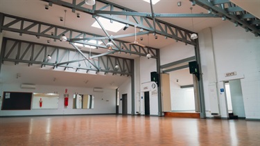 Hall space with lighting, wooden floor and stage