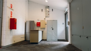 Kitchenette with fridge and bench
