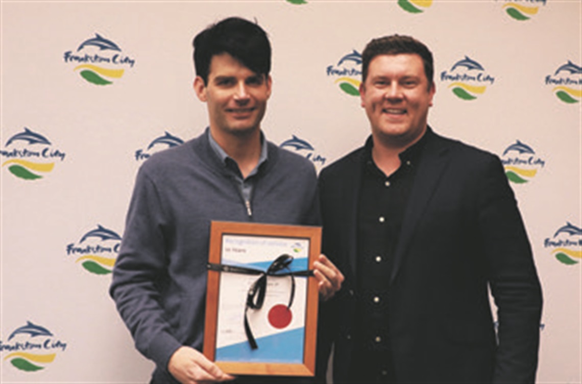 Cr Kris Bolam and Mayor Nathan Conroy posing with a certificate